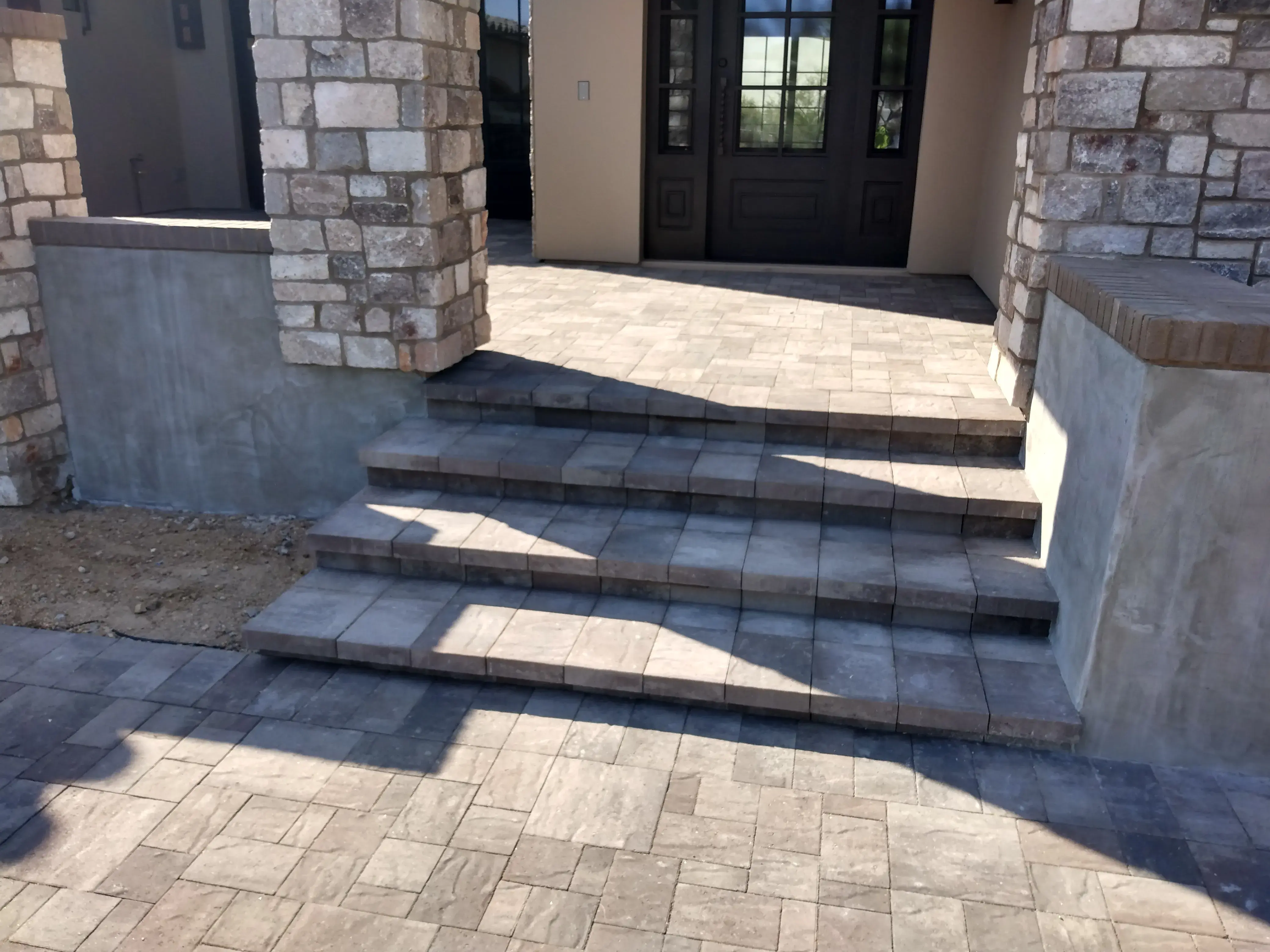 After: Backyard transformation with artificial grass and extended paver patio