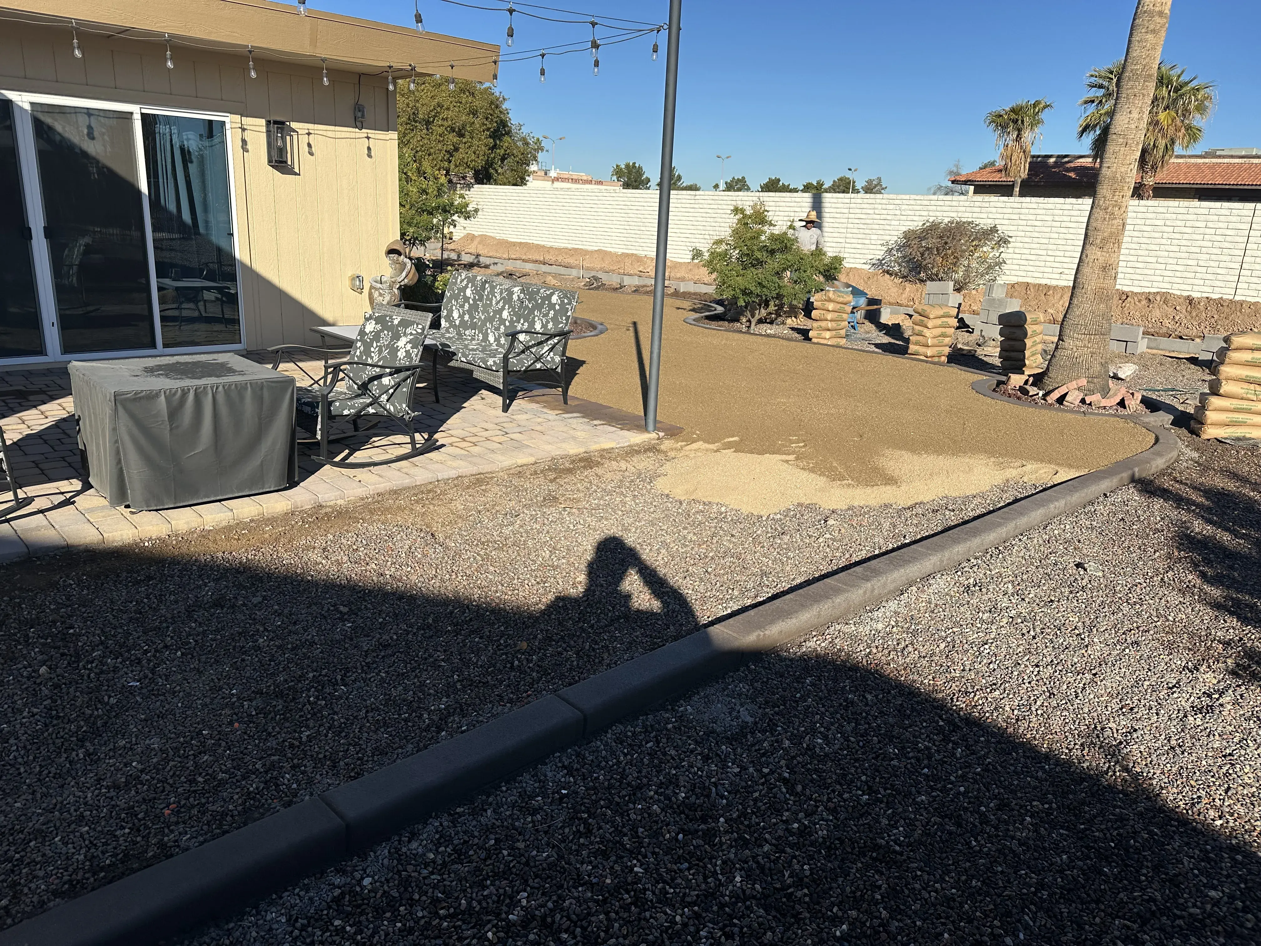 Before: Backyard putting green installation with artificial grass and sand traps