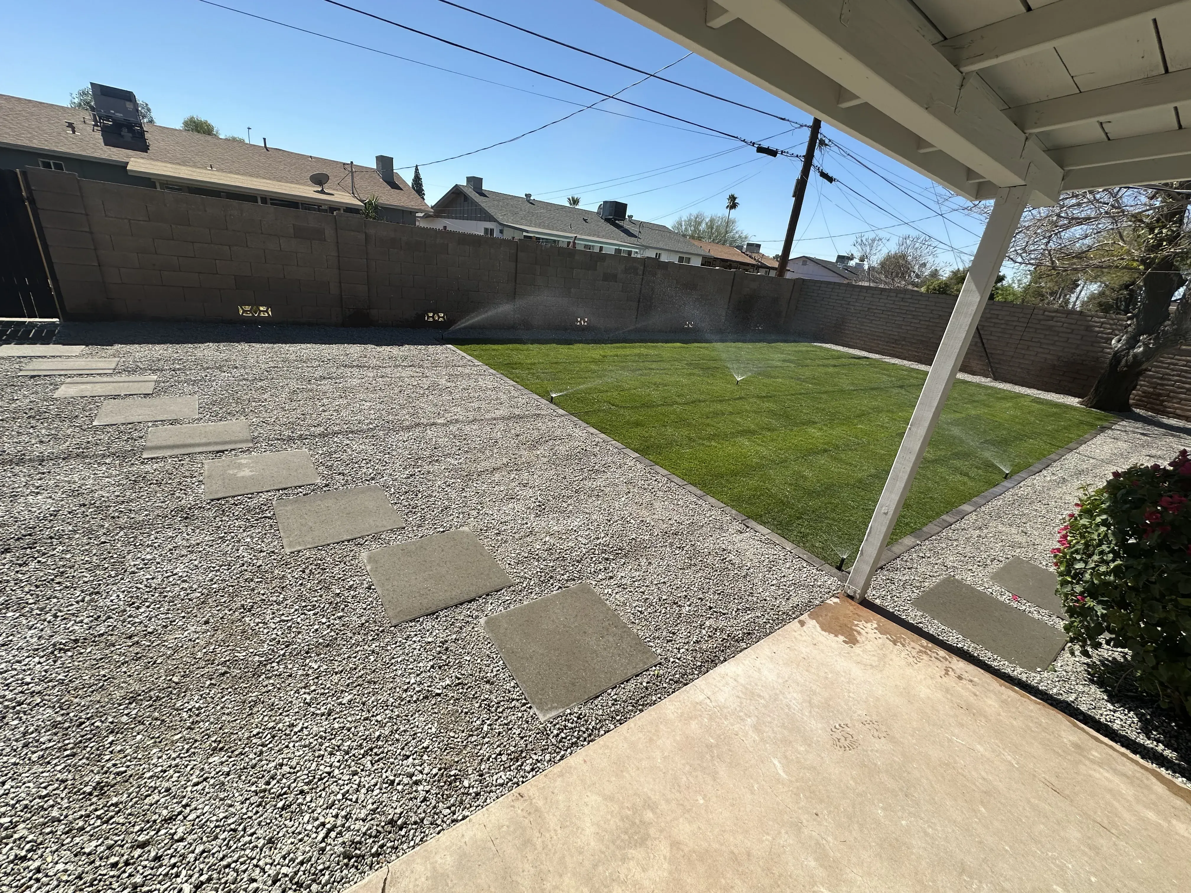 After: Back yard renovation with gravel pathway pavers and sod grass with full sprinkler system installation